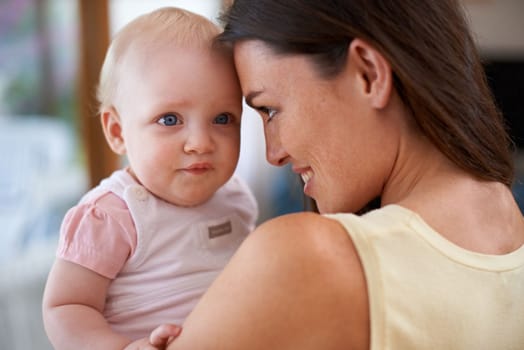 I enjoy bonding with mommy. a mother holding her baby girl at home