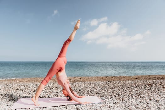 Middle aged well looking woman with black hair doing Pilates with the ring on the yoga mat near the sea on the pebble beach. Female fitness yoga concept. Healthy lifestyle, harmony and meditation.