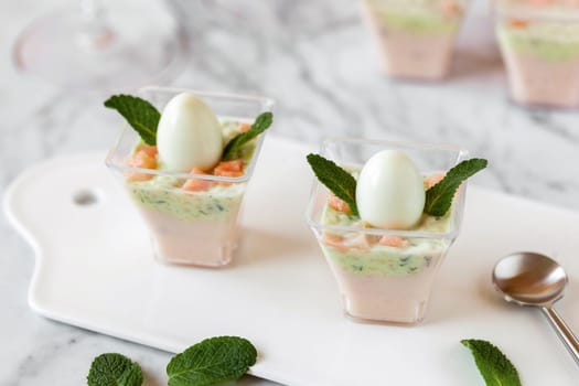 mini portions of salmon and cream mousse decorated with mint leaves, chick imitation, Easter appetizer