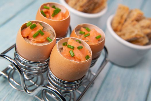 Recipe eggs casserole cooked in the shell with mushroom cream sauce and smoked salmon, High quality photo