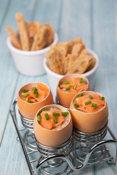 Recipe eggs casserole cooked in the shell with mushroom cream sauce and smoked salmon, High quality photo