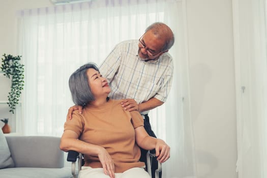 A contented senior couple and their in-home nurse. Elderly female in wheelchair with her young caregiver.