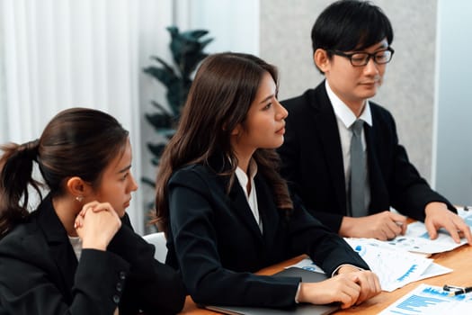 Business team of financial data analysis meeting with business intelligence, report paper and dashboard on laptop for marketing strategy. Business people working together to promote harmony in office.