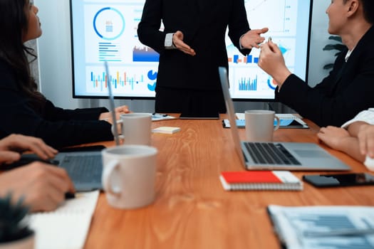 Confidence and asian businessman give presentation on financial analyzed by business intelligence in dashboard report to other people in board room meeting to promote harmony in workplace.