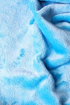 Pleats on blue velvet fabric close up, background or texture