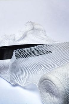 Scissors cut a bandage on a gray background close up
