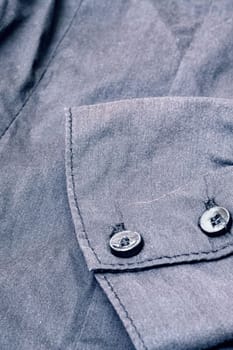 Buttons on a black shirt close up, macro photo
