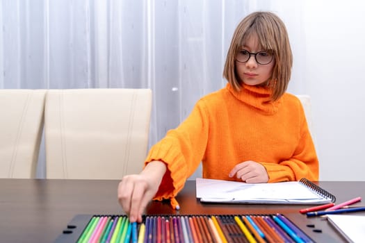 children draw on paper with different colored pencils. High quality photo