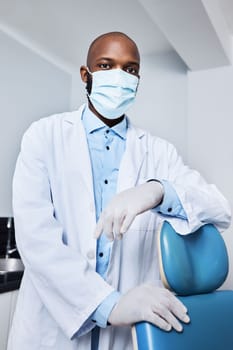 Ready to see the next patient. Portrait of a masked young man working in a dentists office