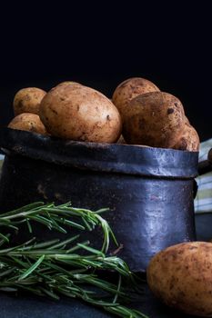 Close up of new potatoes on dark background