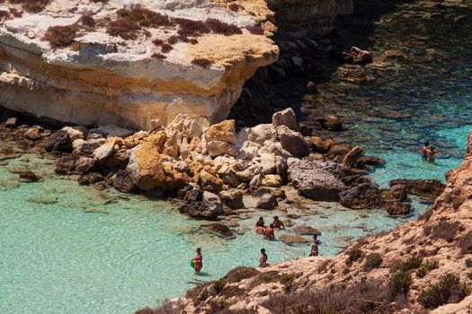 LAMPEDUSA, ITALY - AUGUST, 03: View of the most famous sea place of Lampedusa, It is named Spiaggia dei conigli, in English language Rabbits Beach or Conigli island on August 03, 2018