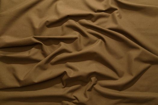 crumpled khaki tan crumpled tan khaki canvas fabric - full frame background and texture.