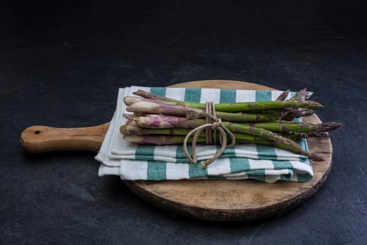 Bunch of fresh asparagus on cutting board