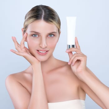 Alluring beautiful perfect cosmetic skin woman portrait hold mockup tube cream or moisturizer for skincare treatment, anti-aging product in isolated background. Natural healthy skin model concept.