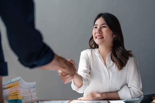 Business handshake for teamwork of business merger and acquisition,successful negotiate,hand shake,two businessman shake hand with partner to celebration partnership and business deal concept....