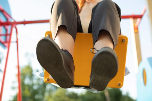 Girl on swing. Teen swinging. Rest in summer. Student's vacation. Girl having fun.