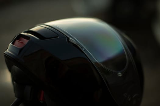 Black motorcyclist helmet. Biker head protection. Safety on road. Motorcycle season is open.