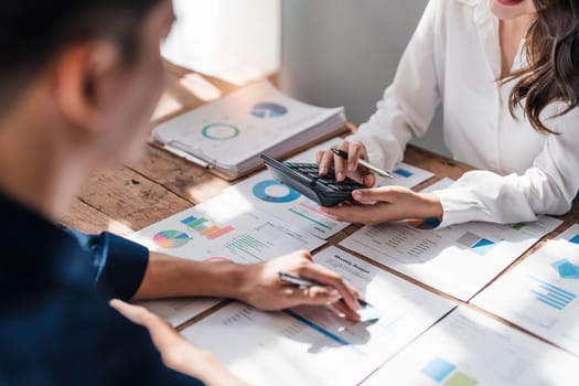 Two business people talk project strategy at office meeting room. Businessman discuss project planning with colleague at modern workplace while having conversation and advice on financial data report...