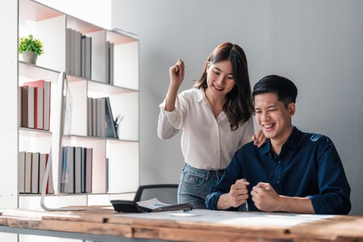 Two business people talk project strategy at office meeting room. Businessman discuss project planning with colleague at modern workplace while having conversation and advice on financial data report...