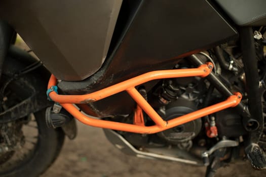 Motorcycle protection. Bike is in details. Orange steel shock blocker. Sports transport.