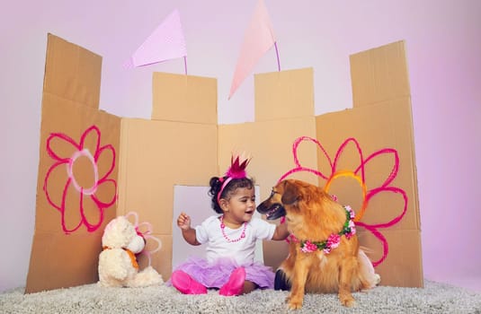 Pets make the cutest playmates. an adorable little girl sitting on the floor and playing with a dog