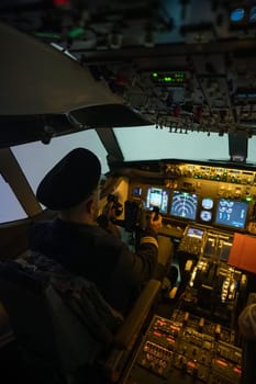 A man is studying to be a pilot in an aircraft simulator