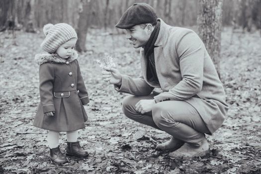 Retro photo of a father giving flowers to a sad daughter.