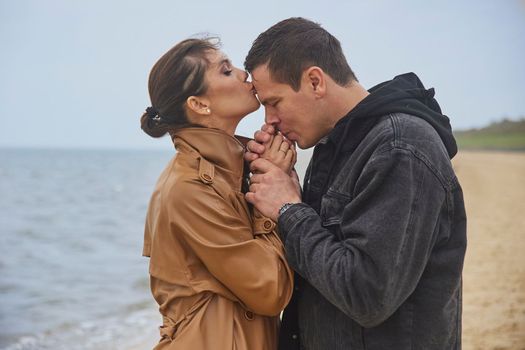 Ribe, Denmark, October, 2022: Newlyweds kissing on the beach.