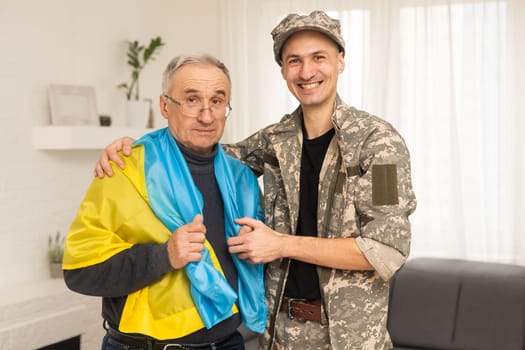 elderly father and son military flag of Ukraine.