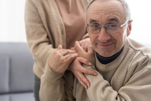 Two people holding hand together. elderly man and support woman.