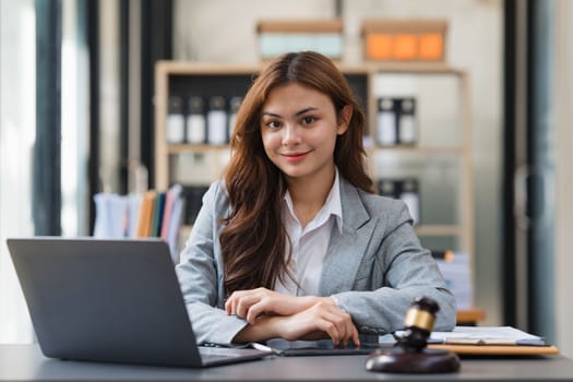 Business Lawyer consulting online on laptop while working at office