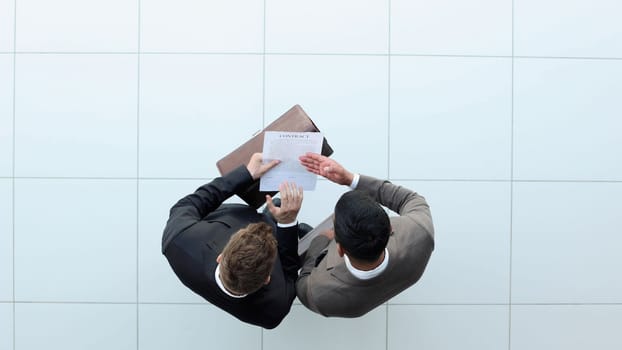 Business Meeting Outdoors, Businessmen Discussing A Contract