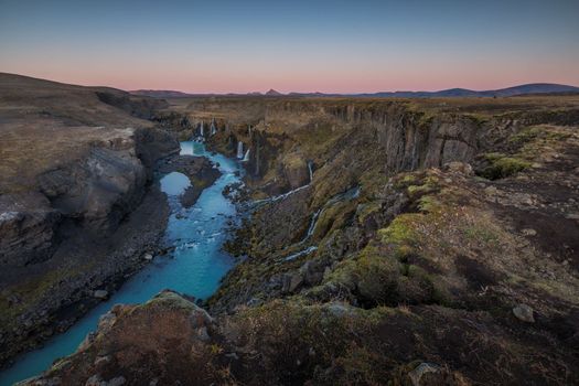 Icelands mountainous landscape combined with northern latitude, which has lots of rain, snow, and glaciers, is why the country has so many waterfalls and cascading water slopes.