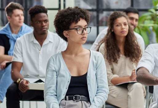 a group of people at a lecture listening attentively to the speaker