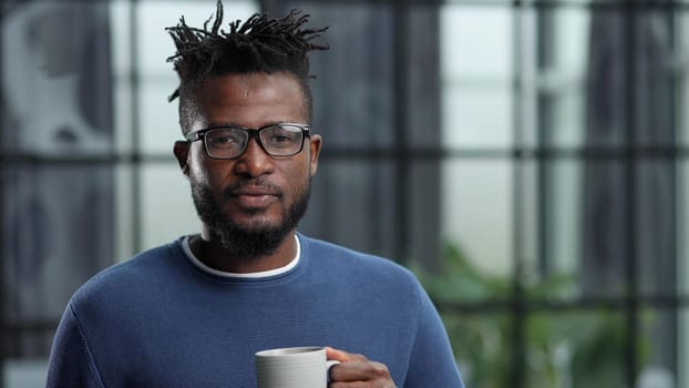 Portrait of a smiling CEO at workplace in a modern office in casual wear with glasses