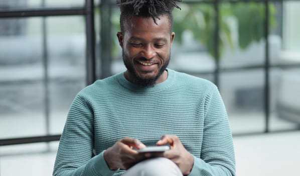 african american businessman using phone mobile corporate apps at workplace texting sms.