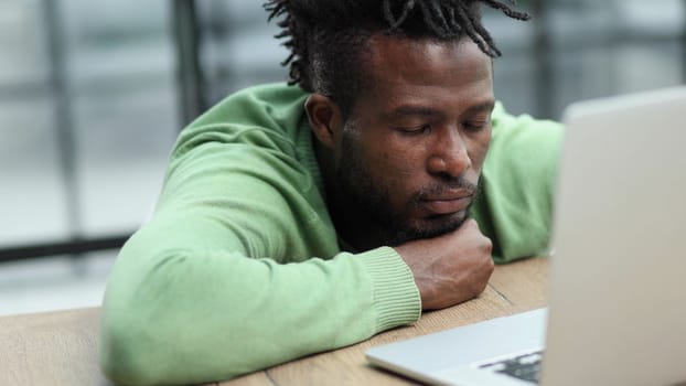 Business man in casual clothes thinking behind a laptop