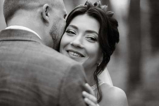 wedding walk of the bride and groom in the deciduous forest in summer