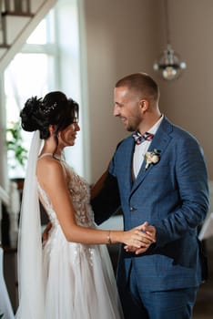 the first dance of the bride and groom inside a restaurant with heavy smoke