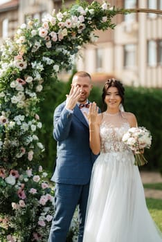 wedding ceremony of the newlyweds on the glade near the restaurant