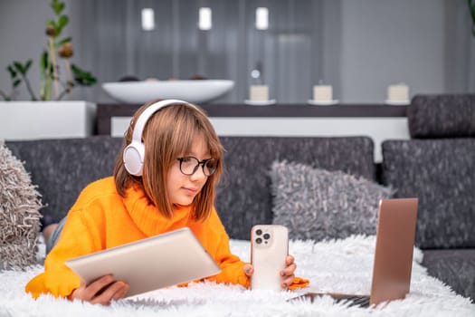 children and modern technology. play and study at home using a laptop, tablet, smartphone and wireless headphones. generation Z