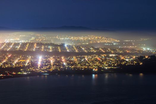 View of lights on straight streets in coastal residential district at night. High quality photo