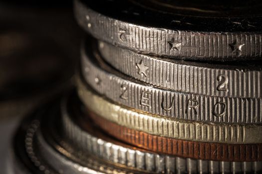 Two euro coin edge. Stack of the coins, close up. Soft focus
