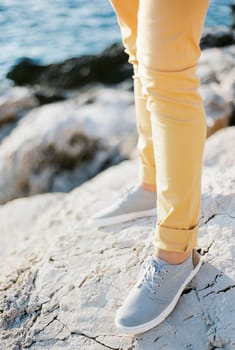 Men legs in trousers and sneakers. Close-up. High quality photo