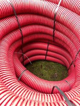 pile of plastic pipes wet from the rain, corrugated burgundy pipes, magenta abstract texture background, color of the year, High quality photo