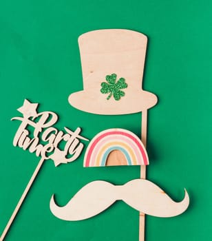 St. Patrick's Day party. Flat lay with hat and greeting card on wooden table. High quality photo