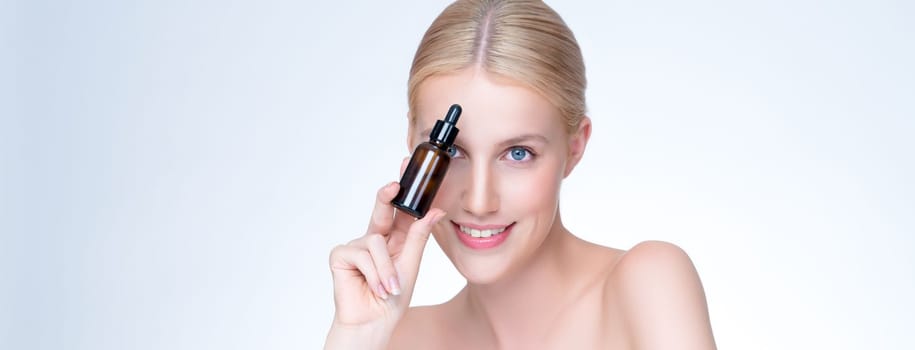 Personable portrait of beautiful woman applying essential oil bottle for skincare product. CBD oil dropper pipette for treatment and extracted cannabis concept in isolated background.