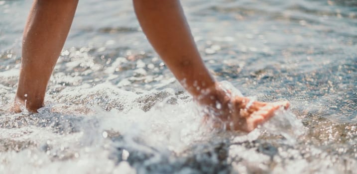 Barefoot woman standing in sea, summer vacation on beach resort. Naked female legs in transparent calm water