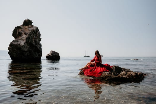 Woman travel sea. Happy tourist taking picture outdoors for memories. Woman traveler looks at the edge of the cliff on the sea bay of mountains, sharing travel adventure journey.