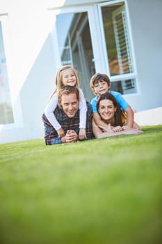 Family always starts at home. a family of four spending time outdoors